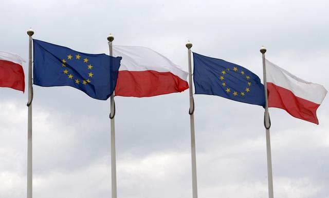 FILE PHOTO - The flags of Poland and European Union flutter in front of the Polish parliament in Warsaw June 29, 2011. REUTERS/Kacper Pempel 