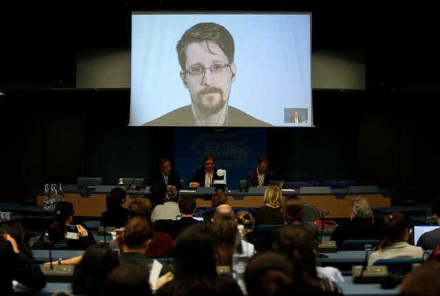 Edward Snowden speaks via video link as he takes part in a round table on the protection of whistleblowers at the Council of Europe in Strasbourg, France, March 15, 2019.   REUTERS/Vincent Kessler