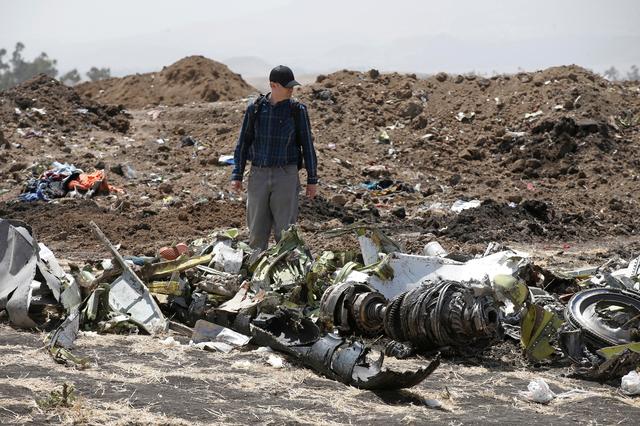 FILE PHOTO -American civil aviation and Boeing investigators search through the debris at the scene of the Ethiopian Airlines Flight ET 302 plane crash, near the town of Bishoftu, southeast of Addis Ababa, Ethiopia March 12, 2019. REUTERS/Baz Ratner/File Photo