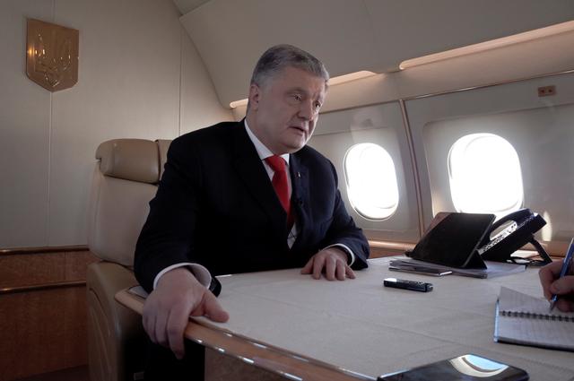 Ukraine's President Petro Poroshenko speaks during an interview with Reuters on board his plane on the way from Berlin to Paris at an unknown location in France, April 12, 2019. REUTERS/Sergiy Karazy
