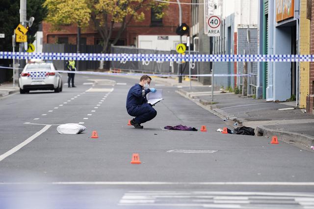 A Victoria Police personnel works at the scene of a multiple shooting outside Love Machine nightclub in Prahran, Melbourne, Australia April 14, 2019. AAP Image/Ellen Smith/via REUTERS  