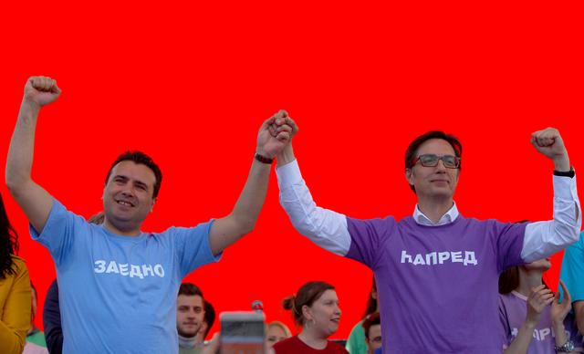Macedonian Prime Minister and leader of the ruling SDSM, Zoran Zaev, and presidential candidate Stevo Pendarovski greet their supporters during a party meeting in Skopje, North Macedonia, April 14, 2019. REUTERS/Ognen Teofilovski