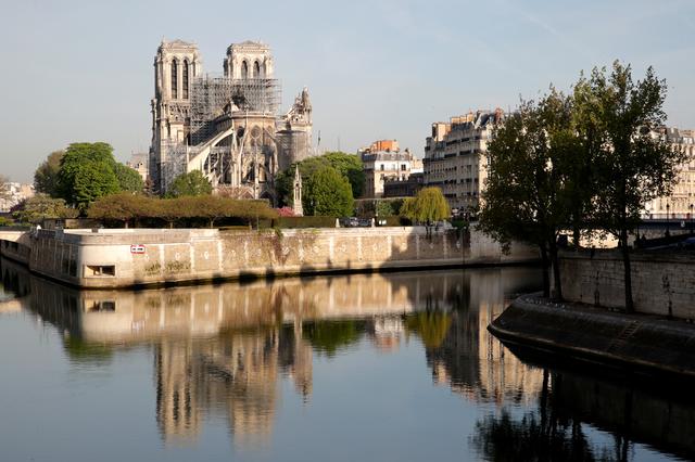 A view shows Notre-Dame Cathedral reflected on the River Seine after a massive fire devastated large parts of the gothic structure in Paris, France, April 18, 2019.  REUTERS/Philippe Wojazer