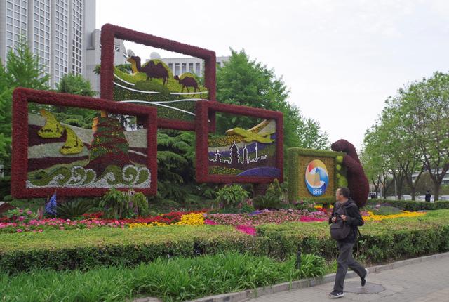 A man walks past a flower installation set up for the upcoming Belt and Road Forum in front of the Chinese Foreign Ministry in Beijing, China April 18, 2019. Picture taken April 18, 2019. Jia Tianyong/CNS via REUTERS 