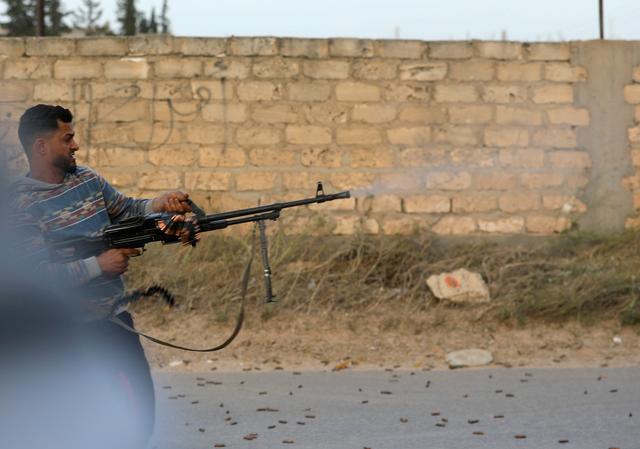 A member of the Libyan internationally recognised government forces fires during fighting with Eastern forces in Ain Zara, Tripoli, Libya April 20, 2019. REUTERS/Hani Amara
