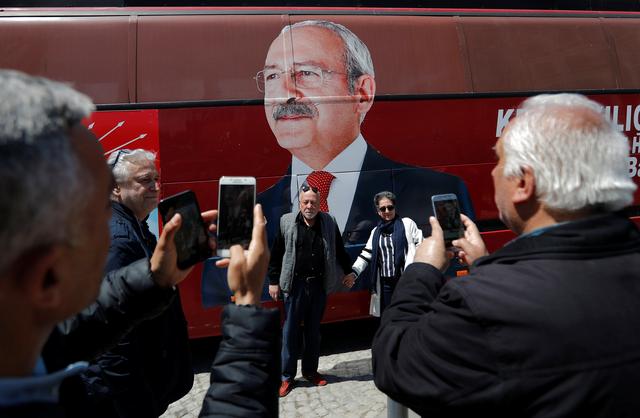 Supporters of the main opposition Republican People's Party (CHP) pose in front of a party bus with a picture of their leader Kemal Kilicdaroglu on it, in Istanbul, Turkey, April 22, 2019. REUTERS/Murad Sezer