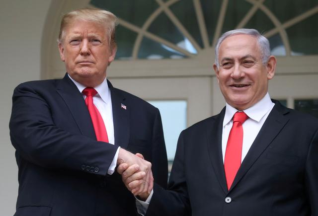 FILE PHOTO: U.S. President Donald Trump shakes hands with Israel's Prime Minister Benjamin Netanyahu as they pose on the West Wing colonnade in the Rose Garden at the White House in Washington, U.S., March 25, 2019. REUTERS/Leah Millis/File Photo