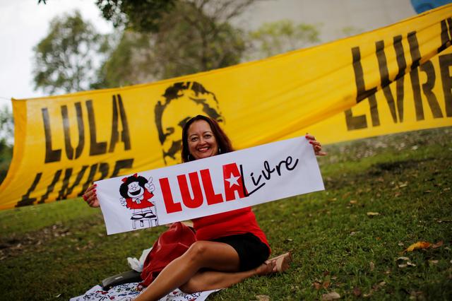 FILE PHOTO: A supporter of Brazil's former president Luiz Inacio Lula da Silva holds a sign reading Free Lula outside the Brazil's Superior Court Justice build during a session to try Lula's appeal in the court in Brasilia, Brazil April  23, 2019. REUTERS/Adriano Machado/File Photo