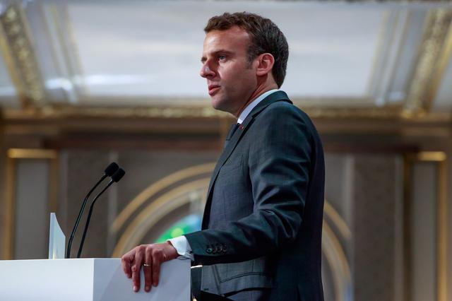 French President Emmanuel Macron delivers a speech for the Parisian Firefighters' brigade and security forces who took part at the fire extinguishing operations during the Notre Dame of Paris Cathedral fire, at Elysee Palace in Paris, France, April 18, 2019. Christophe Petit Tesson/Pool via REUTERS