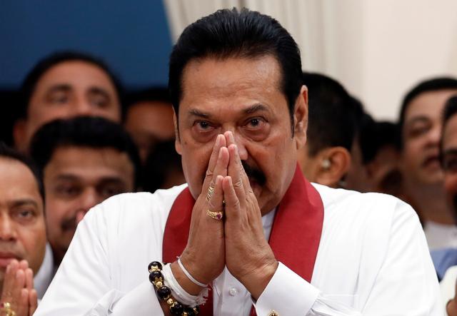 FILE PHOTO: Sri Lanka's newly appointed Prime Minister Mahinda Rajapaksa gestures during the ceremony to assume duties at the Prime Minister's office in Colombo, Sri Lanka October 29, 2018. REUTERS/Dinuka Liyanawatte/File Photo