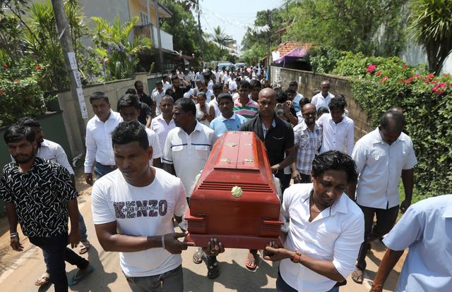 Friends and relatives carry the coffin of eight-month-old Mathew, who died during a string of suicide bomb attacks on churches and luxury hotels on Easter Sunday, at his funeral in Negombo, Sri Lanka April 24, 2019. REUTERS/Athit Perawongmetha