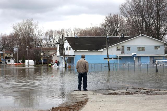 A man looks out at a flooded residential area in Gatineau, Quebec, Canada, April 24, 2019. REUTERS/Chris Wattie