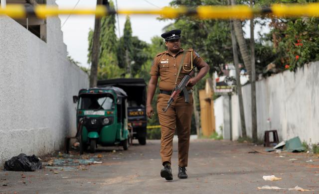 A Sri Lankan police officer walks near the motel, where the Australian and British-educated suicide bomber had detonated his device inside, in Dehiwala on the outskirts of Colombo, Sri Lanka April 26, 2019. REUTERS/Dinuka Liyanawatte