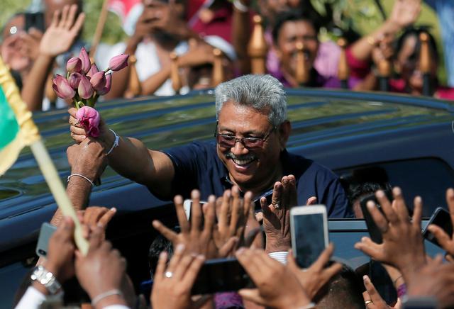 Sri Lanka's former defense secretary Gotabaya Rajapaksa greets his supporters after his return from the United States, in Katunayake, Sri Lanka April 12, 2019. REUTERS/Dinuka Liyanawatte
