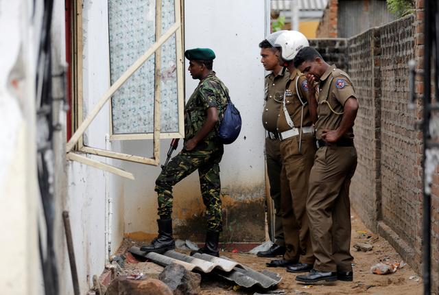 Security personnel seen at the site of an overnight gun battle, between troops and suspected Islamist militants, on the east coast of Sri Lanka, in Kalmunai, April 27, 2019. REUTERS/Dinuka Liyanawatte