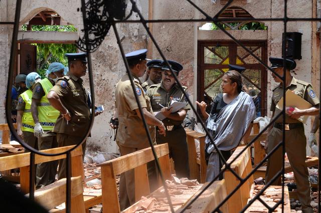 Crime scene officials inspect the site of a bomb blast inside a church in Negombo, Sri Lanka April 21, 2019. REUTERS/Stringer NO ARCHIVES. NO RESALES.