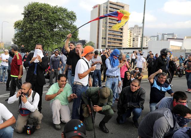 People react near the Generalisimo Francisco de Miranda Airbase La Carlota, in Caracas, Venezuela April 30, 2019. REUTERS/Manaure Quintero NO RESALES. NO ARCHIVES