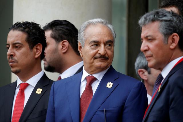 FILE PHOTO: Khalifa Haftar (C), the military commander who dominates eastern Libya, leaves after an international conference on Libya at the Elysee Palace in Paris, France, May 29, 2018.  REUTERS/Philippe Wojazer/File Photo