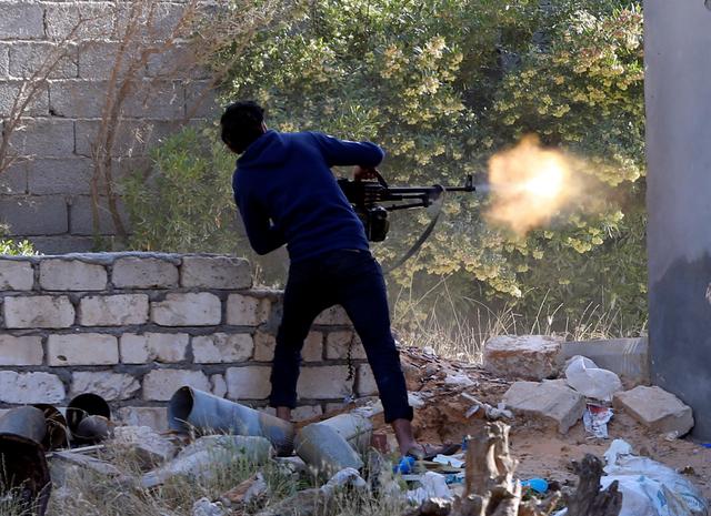 FILE PHOTO - A member of the Libyan internationally recognised government forces fires during a fight with Eastern forces in Ain Zara, Tripoli, Libya April 28, 2019. REUTERS/Ismail Zitouny