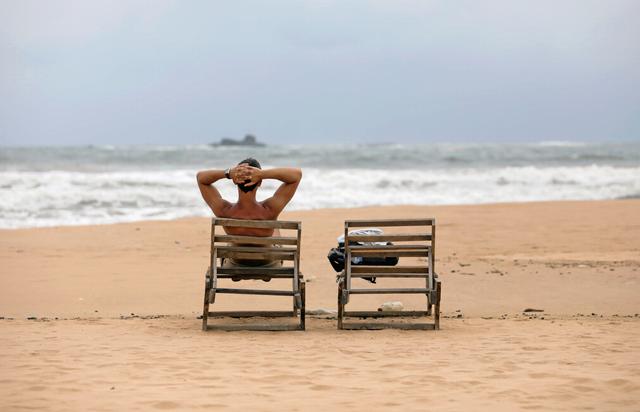 A tourist rests on a beach near hotels in a tourist area in Bentota, Sri Lanka May 2, 2019. Picture take May 2, 2019. REUTERS/Dinuka Liyanawatte