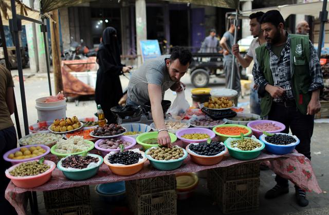 A Palestinian man sells olives and pickles on the first day of the Muslim holy month of Ramadan, in the southern Gaza Strip May 6, 2019. REUTERS/Ibraheem Abu Mustafa