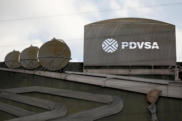 FILE PHOTO: Cutouts depicting images of oil operations are seen outside a building of Venezuela's state oil company PDVSA in Caracas, Venezuela January 28, 2019. REUTERS/Carlos Garcia Rawlins/File Photo/File Photo