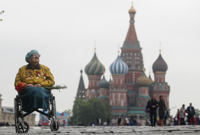 A veteran sits in a wheelchair in front of St. Basil's Cathedral after the Victory Day parade, which marks the anniversary of the victory over Nazi Germany in World War Two, in Red Square in central Moscow, Russia May 9, 2019. REUTERS/Maxim Shemetov
