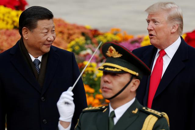 FILE PHOTO: U.S. President Donald Trump takes part in a welcoming ceremony with China's President Xi Jinping at the Great Hall of the People in Beijing, China, November 9, 2017. REUTERS/Damir Sagolj/File Photo