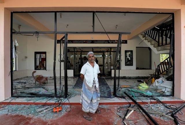 A Muslim man stands in front of the Abbraar Masjid mosque after a mob attack in Kiniyama, Sri Lanka May 13, 2019. REUTERS/Dinuka Liyanawatte  