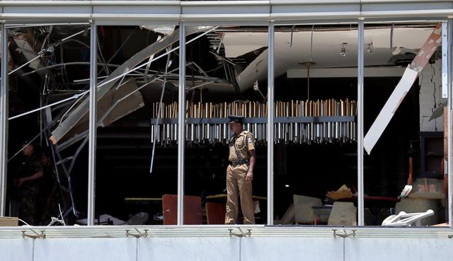 FILE PHOTO: A police officer inspects the explosion area at Shangri-La hotel in Colombo, Sri Lanka April 21, 2019. REUTERS/Dinuka Liyanawatte/File Photo
