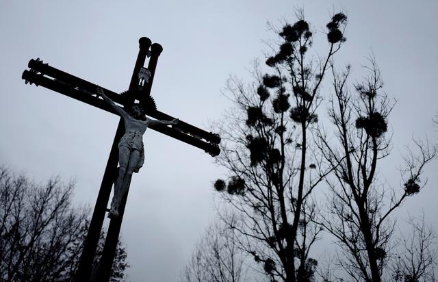 FILE PHOTO: A cross is seen near trees with mistletoe near the church in Kalinowka, Poland November 25, 2018. REUTERS/Kacper Pempel/File Photo