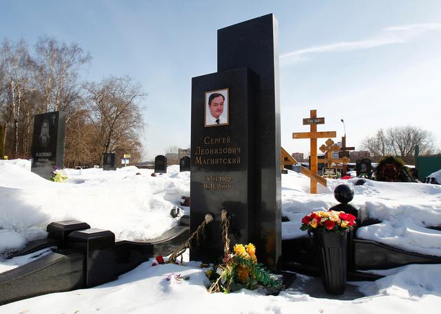 FILE PHOTO: Flowers lie near the grave of lawyer Sergei Magnitsky in the Preobrazhensky cemetery in Moscow March 11, 2013. REUTERS/Mikhail Voskresensky
