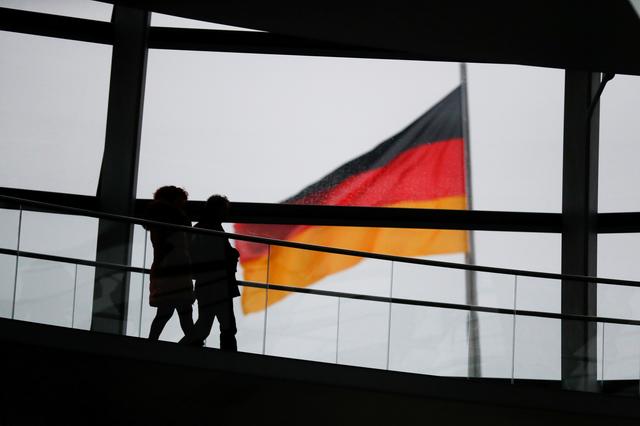 FILE PHOTO: Visitors walk inside the glass dome of the Reichstag building, the seat of the German lower house of parliament Bundestag in Berlin, Germany,  January 12, 2018.  REUTERS/Hannibal Hanschke - RC180CE99100/File Photo