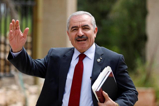 FILE PHOTO:  Palestinian Prime Minister Mohammad Shtayyeh gestures as he arrives for a cabinet meeting of the new Palestinian government, in Ramallah, in the Israeli-occupied West Bank April 15, 2019. REUTERS/Mohamad Torokman