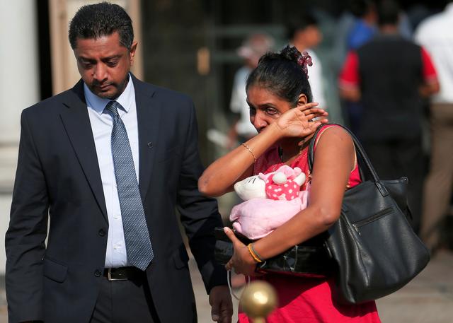 Devotees cry in front of St Anthony's church, one of the churches attacked in the April 21st Easter Sunday Islamic militant bombings, during the first-month remembrance service, in Colombo, Sri Lanka May 21, 2019. REUTERS/Dinuka Liyanawatte