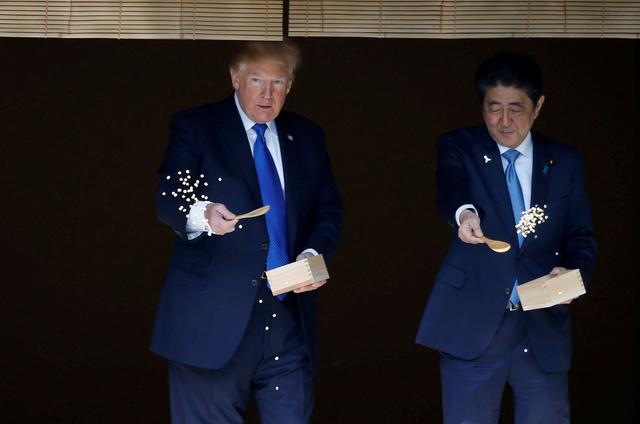 FILE PHOTO : U.S. President Donald Trump and Japan's Prime Minister Shinzo Abe feed carp before their working lunch at Akasaka Palace in Tokyo, Japan November 6, 2017. REUTERS/Toru Hanai/File Photo