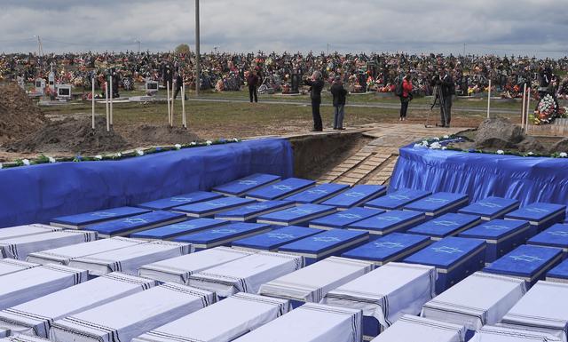 People attend a ceremony to rebury the remains of Jews killed by Nazis in a local ghetto during World War Two, which were recently found at a construction site in a residential area, in the city of Brest, Belarus May 22, 2019. REUTERS/Stringer
