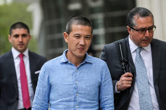 FILE PHOTO: Ex-Goldman Sachs banker Roger Ng (center) and his lawyer Marc Agnifilo leave the federal court in New York, U.S., May 6, 2019. REUTERS/Jeenah Moon/File Photo