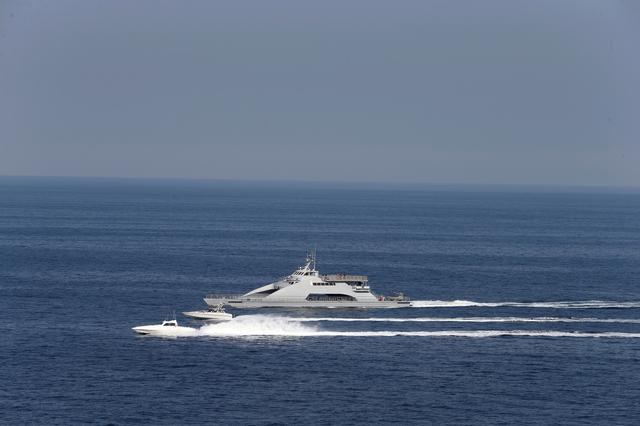 FILE PHOTO: Iranian Revolutionary Guards speed boats are seen near the USS John C. Stennis CVN-74 (not pictured) as it makes its way to gulf through strait of Hormuz, December 21, 2018. REUTERS/Hamad I Mohammed/File Photo