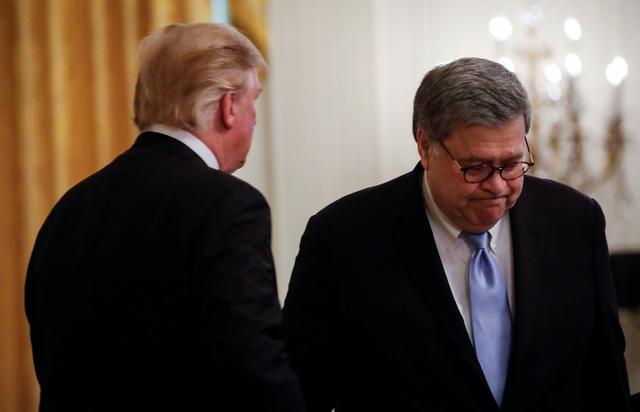 FILE PHOTO - U.S. Attroney General William Barr passes President Donald Trump as he heads to the podium to speak during the presentation of Public Safety Medals of Valor to officers in the East Room of the White House in Washington, U.S., May 22, 2019. REUTERS/Carlos Barria