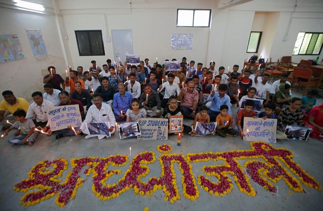FILE PHOTO: People attend a prayer meet to pay tribute to the victims of a fire that broke out in a commercial building in the western city of Surat on Friday, inside a library in Ahmedabad, India, May 25, 2019. REUTERS/Amit Dave