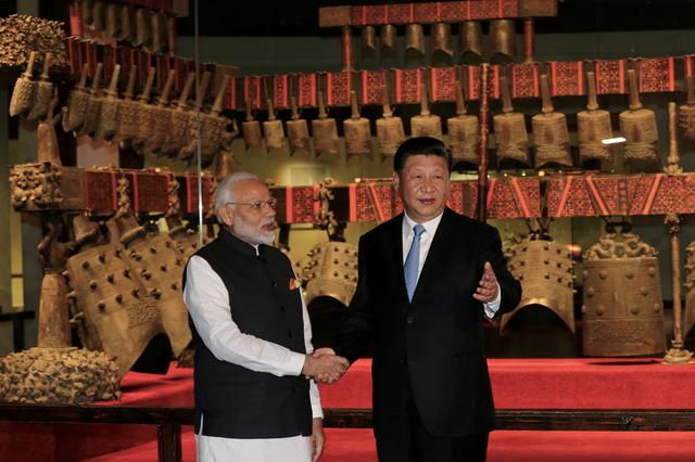 FILE PHOTO: Chinese President Xi Jinping and Indian Prime Minister Narendra Modi shake hands as they visit the Hubei Provincial Museum in Wuhan, Hubei province, China April 27, 2018. China Daily via REUTERS/File Photo 