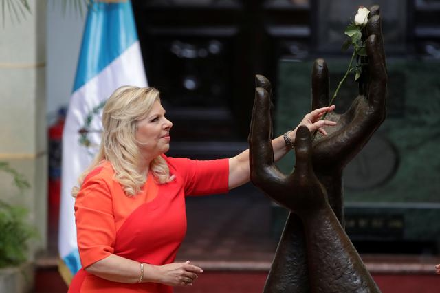 Sara Netanyahu, wife of Israeli Prime Minister Benjamin Netanyahu, holds a rose, which symbolises peace, during the Changing of the Rose ceremony at the National Palace in Guatemala City, Guatemala December 11, 2018. REUTERS/Luis Echeverria