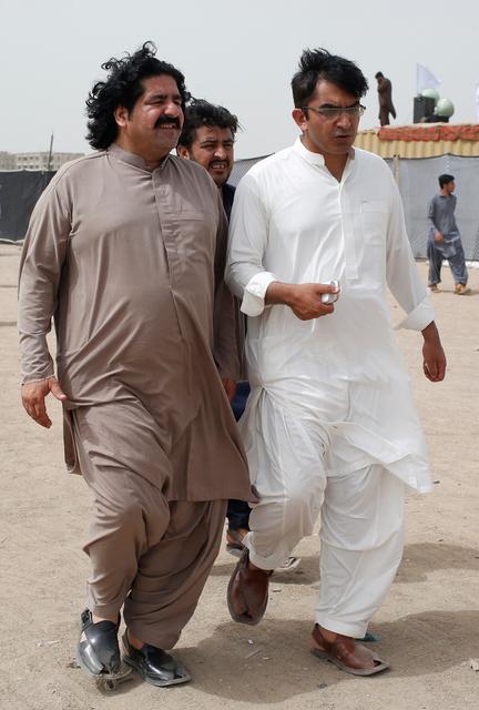FILE PHOTO: Ali Wazir (L) and Mohsin Dawar, leaders of the Pashtun Tahaffuz Movement (PTM) walks at the venue of a rally against, what they say, are human rights violations by security forces, in Karachi, Pakistan May 13, 2018. REUTERS/Akhtar Soomro/File Photo