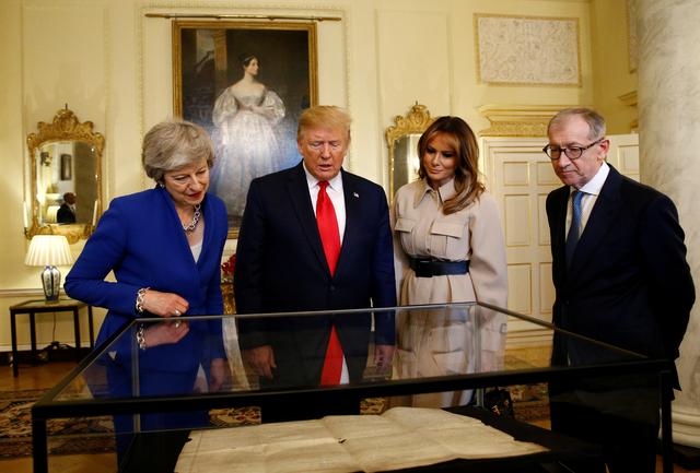 U.S. President Donald Trump and first lady Melania Trump review items with Britain's Prime Minister Theresa May and her husband Philip in Downing Street, as part of Trump's state visit in London, Britain, June 4, 2019. REUTERS/Henry Nicholls/Pool