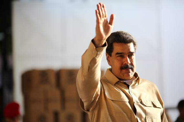 FILE PHOTO: Venezuela's President Nicolas Maduro waves during his visit to a packing center of the CLAP (Local Committees of Supply and Production) program, a Venezuelan government handout of basic food supplies, in Caracas, Venezuela May 28, 2019. Miraflores Palace/Handout via REUTERS
