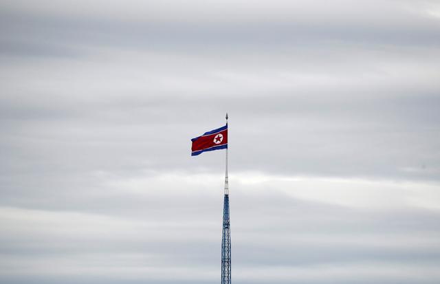 FILE PHOTO: A North Korean flag flutters on top of a 160-metre tower in North Korea's propaganda village of Gijungdong, in this picture taken from the Tae Sung freedom village near the Military Demarcation Line (MDL), inside the demilitarised zone separating the two Koreas, in Paju, South Korea, April 24, 2018. REUTERS/Kim Hong-Ji