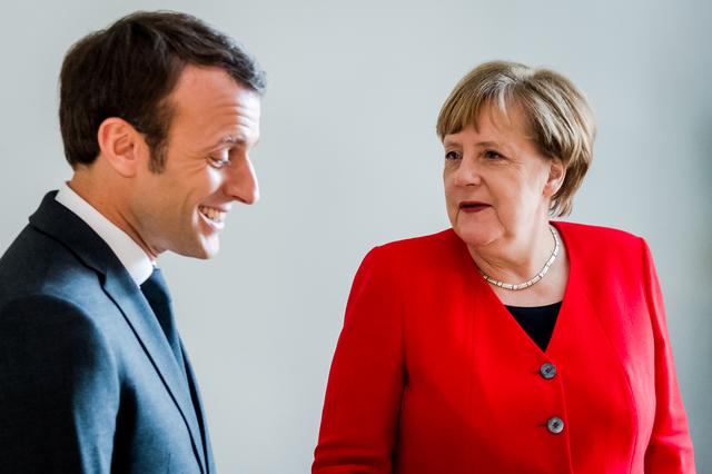 FILE PHOTO: French President Emmanuel Macron and German Chancellor Angela Merkel meet on the sidelines of an EU summit in Brussels, Belgium March 21, 2019. Geert Vanden Wijngaert/Pool via Reuters/File Photo
