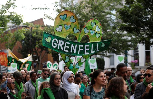 FILE PHOTO - Participants in a Silent March mark the first anniversary of the Grenfell Tower fire in London, Britain June 14, 2018. REUTERS/Peter Nicholls