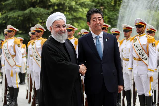 Iranian President Hassan Rouhani shakes hands with Japan's Prime Minister Shinzo Abe, during a welcome ceremony in Tehran, Iran, June 12, 2019. Official Iranian President website/Handout via REUTERS